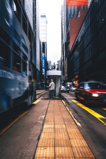 Person Standing Between Vehicles 