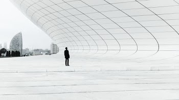 person standing in a middle of white plate field