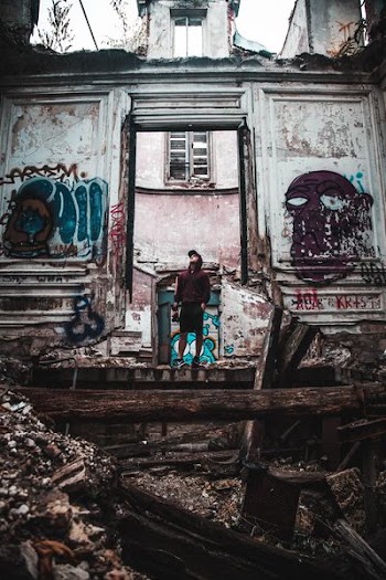 person standing in front of abandon building
