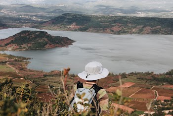 Person Standing in Front of Calm Body of Water