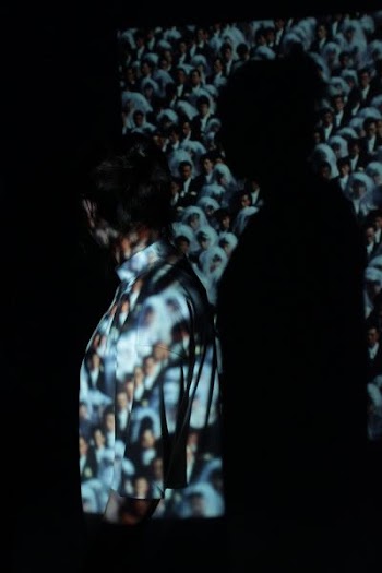person standing in front of LED projector