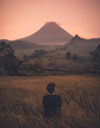 person standing in front of mountain