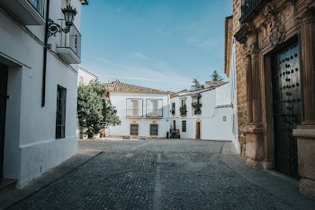 Person Standing in Front of White Building