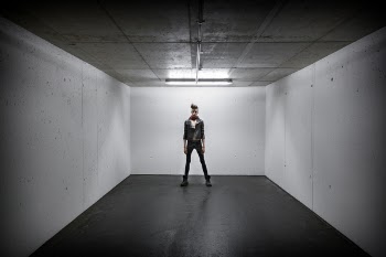 Person Standing Inside White Wall Box Room