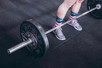 Person Standing Near Black Barbell