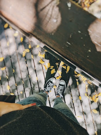 Person Standing Near Brown Wooden Surface