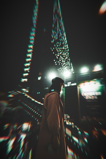 Person Standing Near Building in Selective Focus Photography