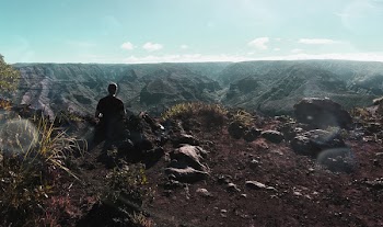 Person Standing Near Cliff