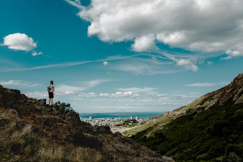 Person Standing Near Cliff