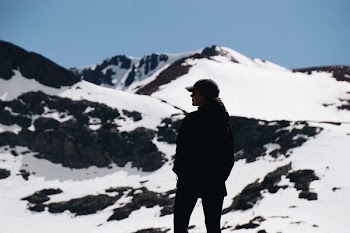 person standing near mountain covered with snow