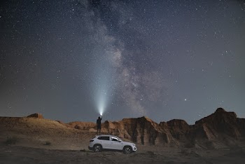 Person Standing Near Vehicle During Nighttime