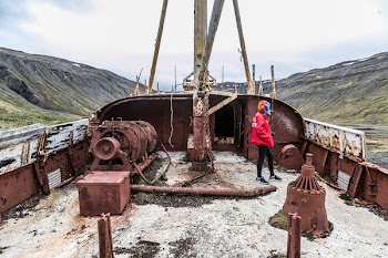 Person Standing on Abandoned Ship