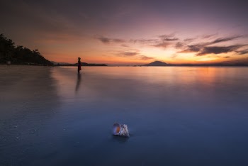 Person Standing On Beach