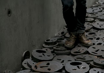 Person Standing on Black Steel Round Face Plates