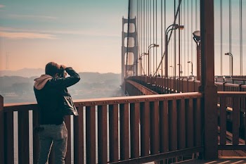 person standing on bridge taking picture