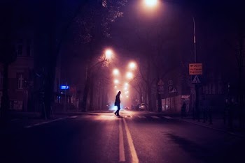 person standing on center asphalt road