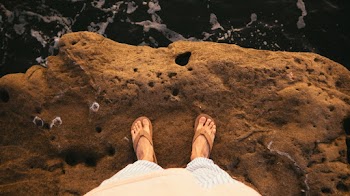 Person Standing On Cliff Wearing Brown Flip-flops