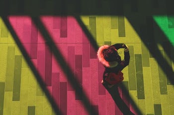 person standing on colored parquet flooring