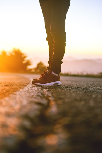 Person Standing On Concrete Road