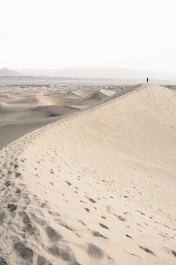 person standing on desert during daytime