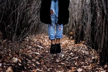 person standing on dried leaves