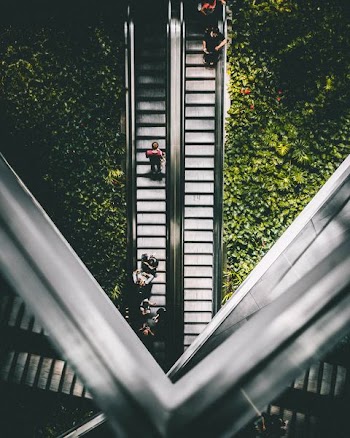 person standing on escalator