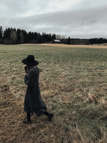Person Standing on Grass Field