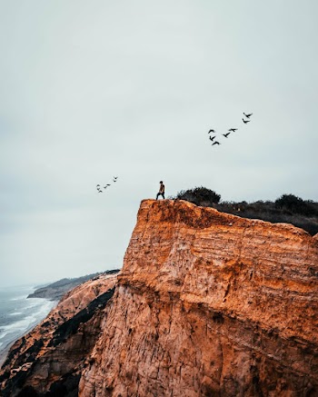 Person Standing on Mountain