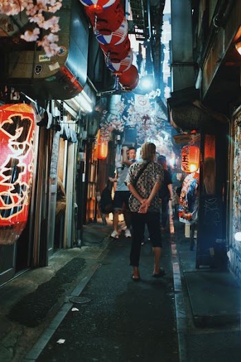 person standing on pathway at night