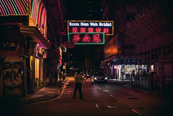 Person Standing on Paved Road