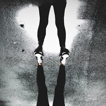 Person Standing on Puddle