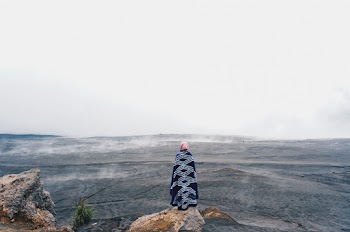 Person Standing on Rock