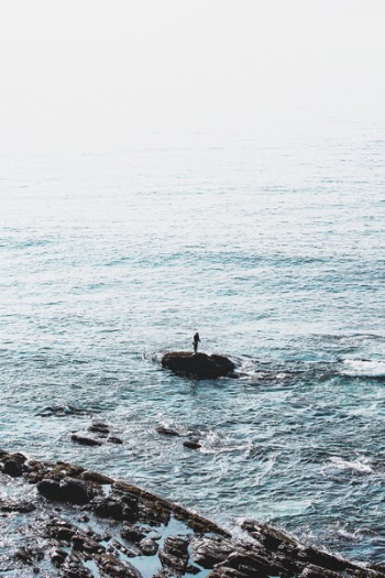 Person Standing on Rock Formation