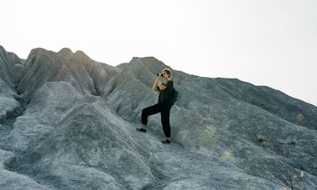 person standing on rock formation