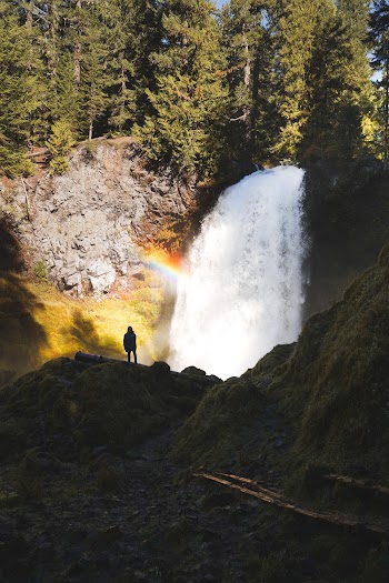 Person Standing On Rock Looking At Waterfalls