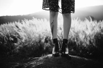 Person Standing on Rock Near Field