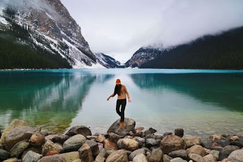 person standing on rock seashore during daytime