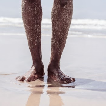 Person Standing on Seashore