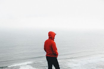 person standing on seashore during daytime