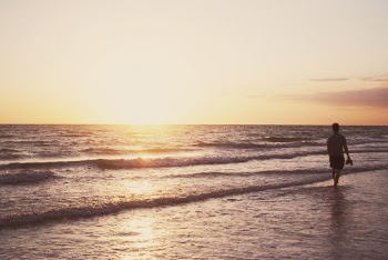 Person Standing on Seashore During Golden Hour