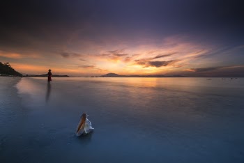 Person Standing on Shallow Water during Golden Hour