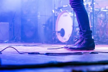person standing on stage near drum
