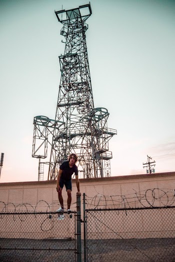 Person Standing on Steel Fence