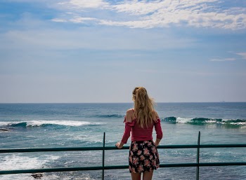 Person Standing on Terrace Facing Sea
