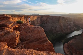 person standing on top of canyon during daytime