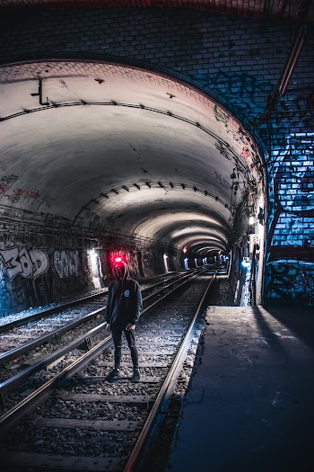 Person Standing on Train Tracks