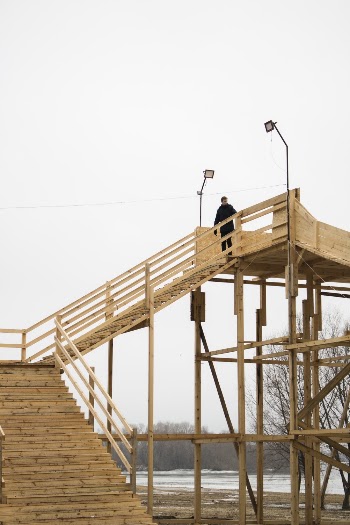 Person Standing on Wooden Bridge