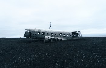 Person Standing on Wrecked Plane