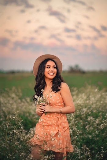 Person Standing Outdoors Holding Flowers