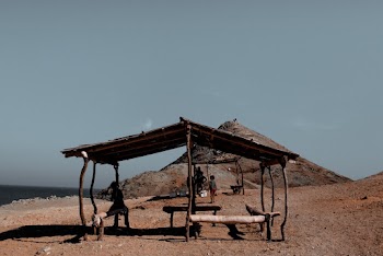 Person Standing Under Hut